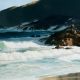 This painting shows the southern end of Lighthouse Beach on the NSW coast. It is afternoon and the headland is throwing a shadow across the rocks and the sea below.